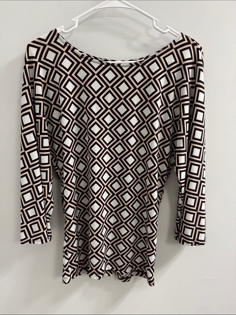 NEW YORK AND COMPANY geometric blouse with bell sleeves.